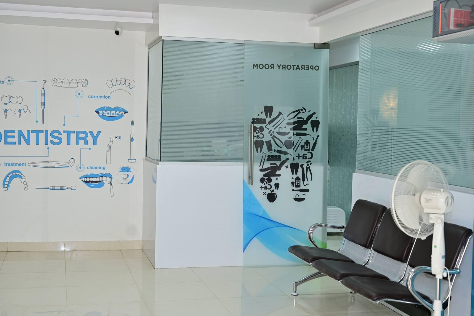 Calm, modern waiting area with dentistry wall art at The Tooth Corner