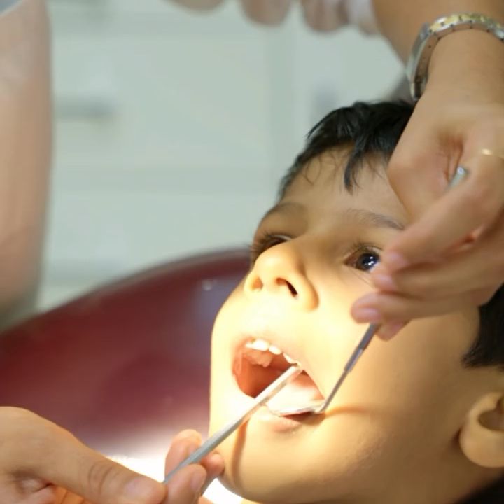Dr. Shabnam gently examining a young child at The Tooth Corner, Bellandur
