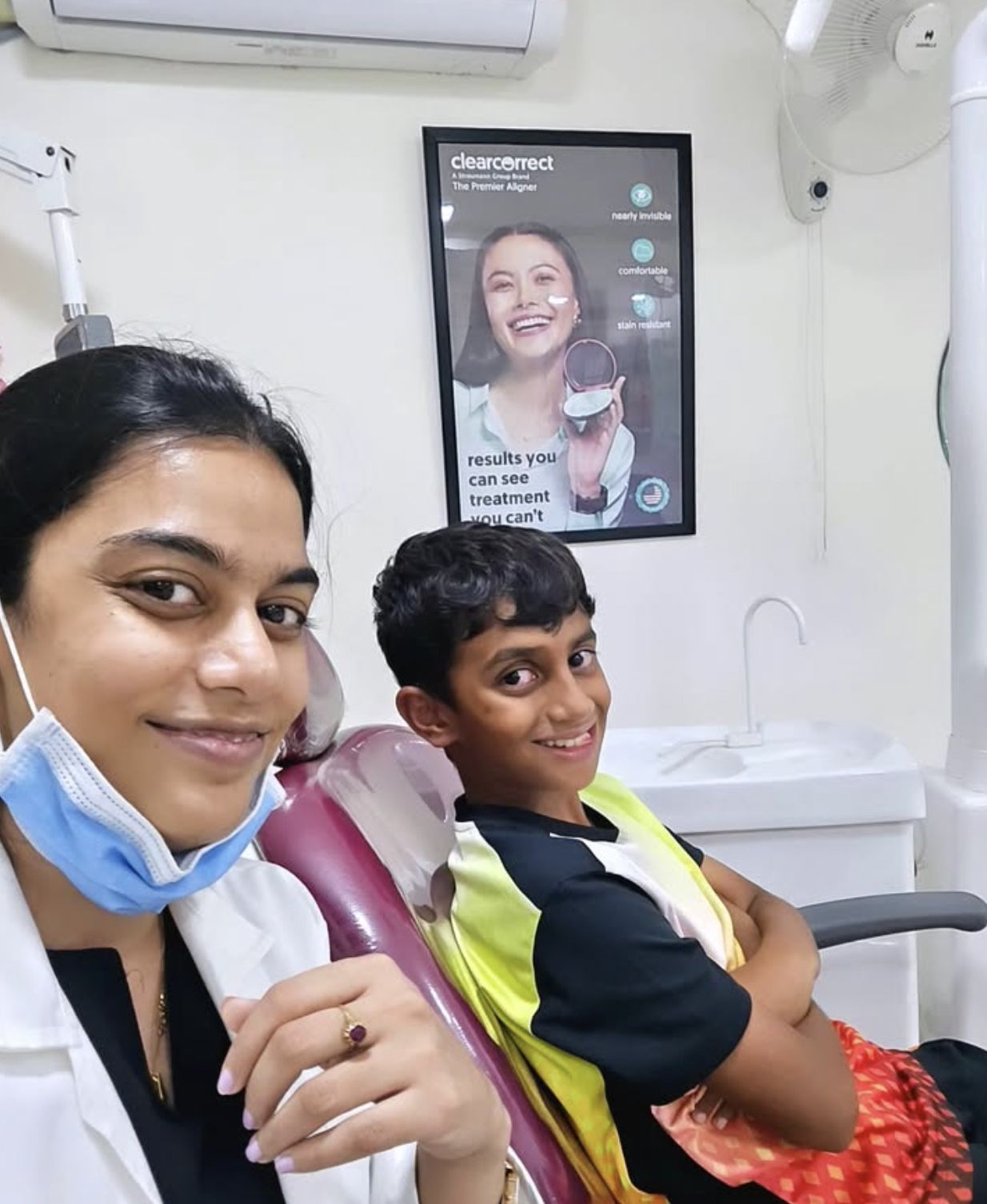 Dr. Shabnam with a smiling young patient in the dental chair