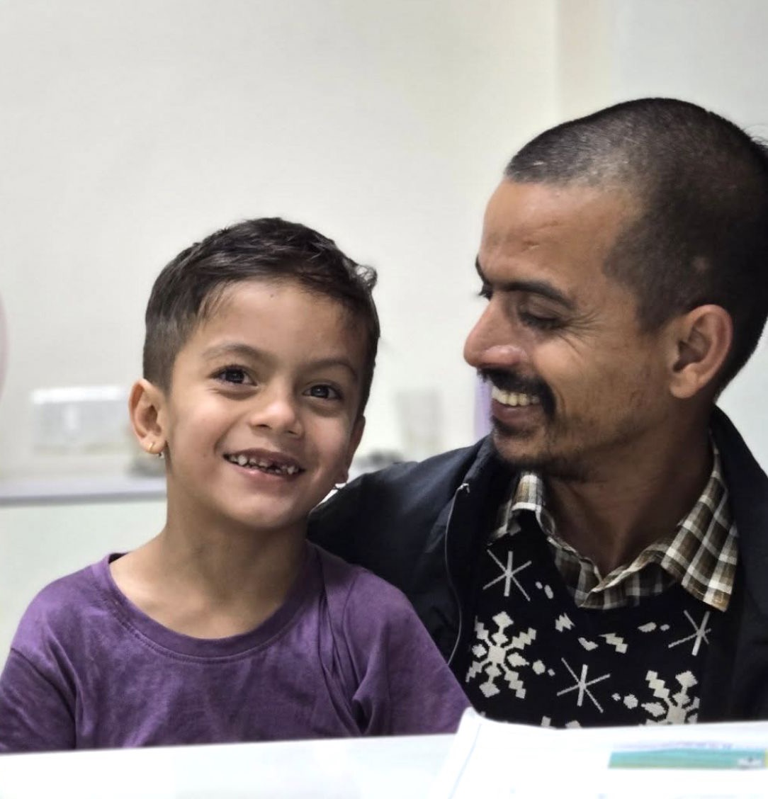 A father and his young son sharing a laugh at The Tooth Corner