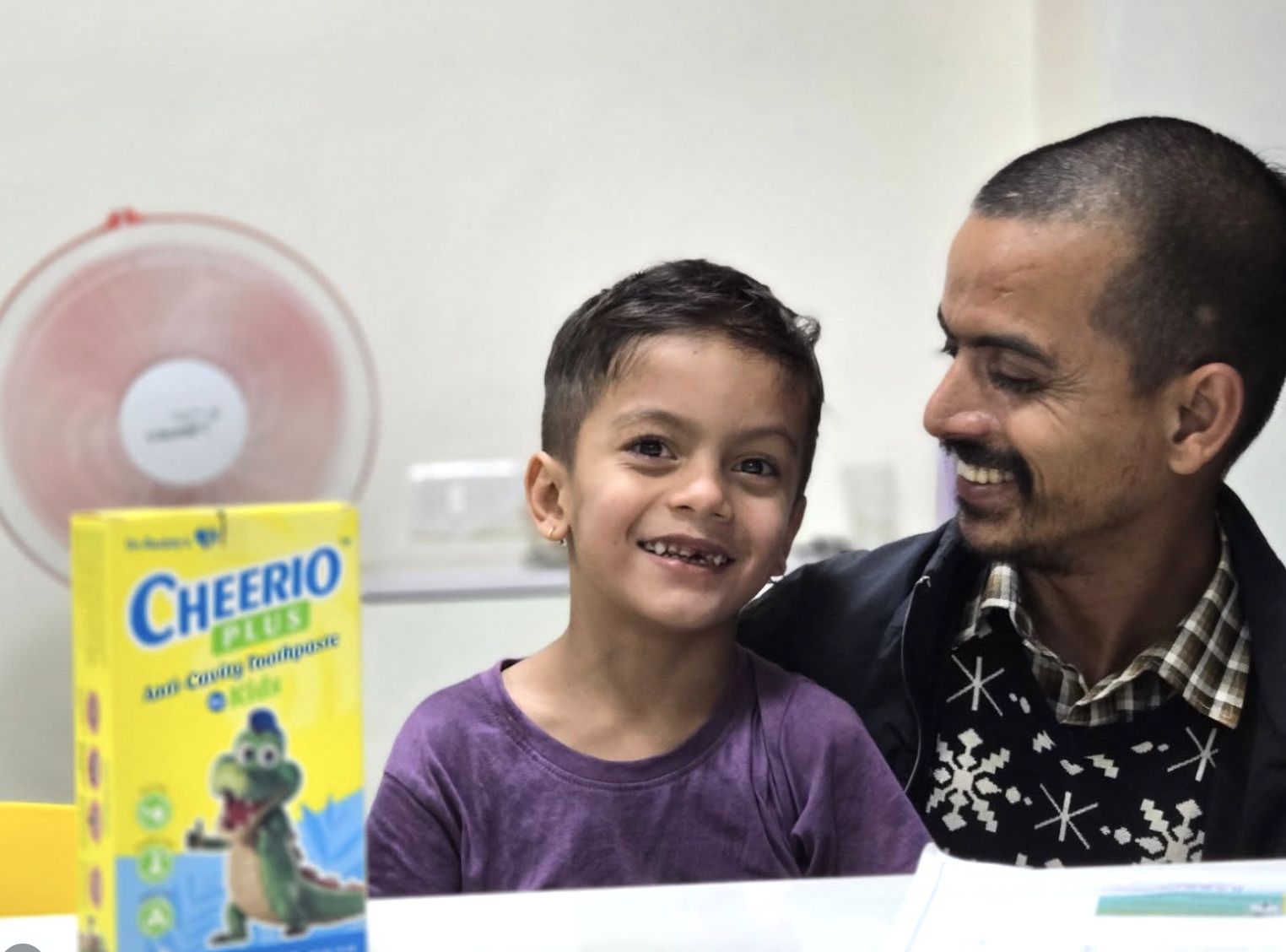 A father and his young son sharing a laugh at The Tooth Corner