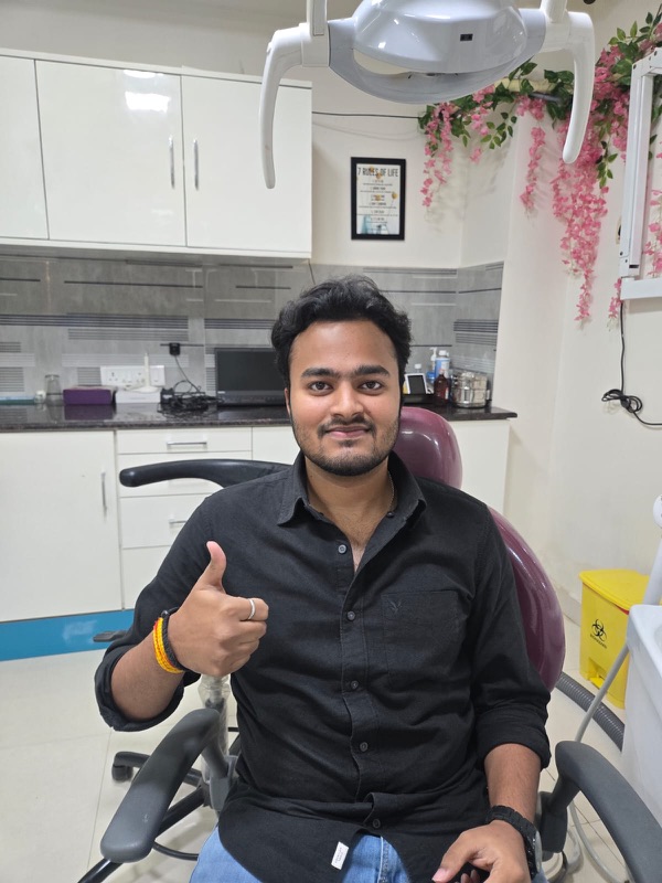 A happy patient giving a thumbs up after treatment at The Tooth Corner