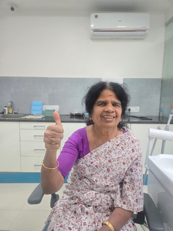 A happy patient giving a thumbs up after treatment at The Tooth Corner, Bellandur