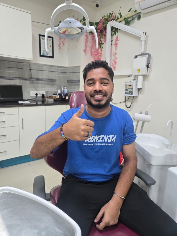 A happy patient giving a thumbs up after treatment at The Tooth Corner
