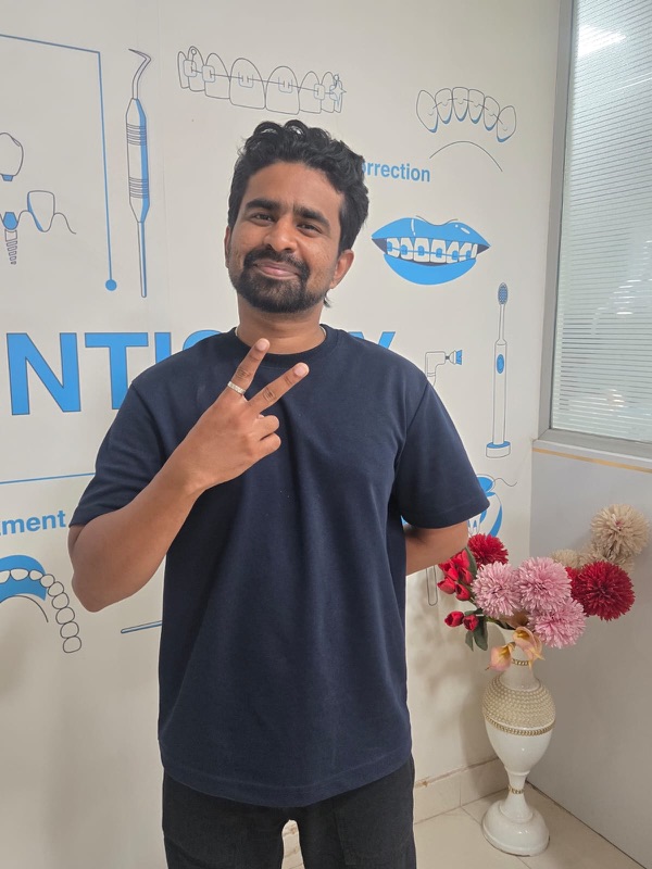 A happy patient giving a thumbs up after treatment at The Tooth Corner
