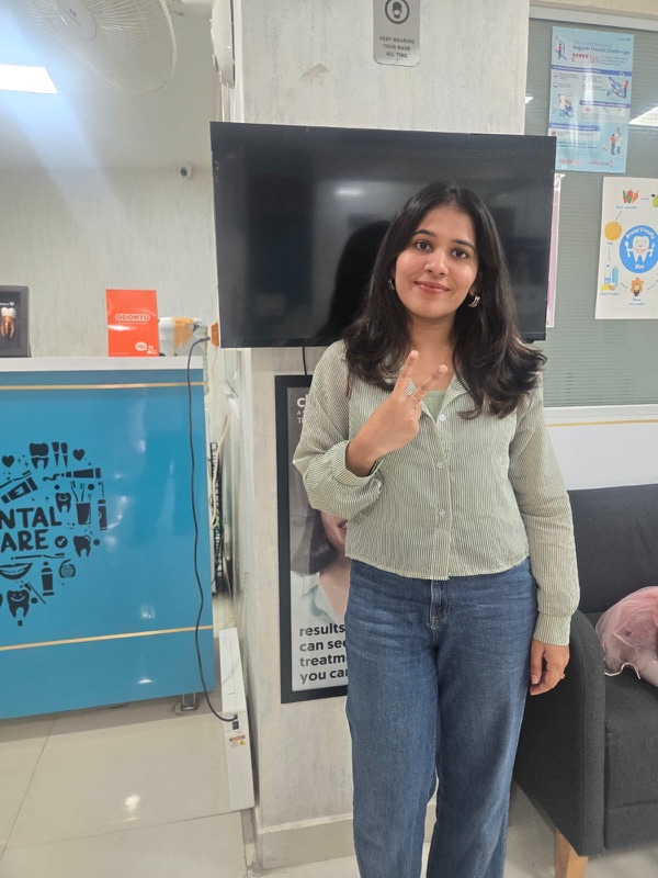 A happy patient giving a thumbs up after treatment at The Tooth Corner