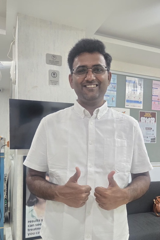 A happy patient of The Tooth Corner with a bright, confident smile