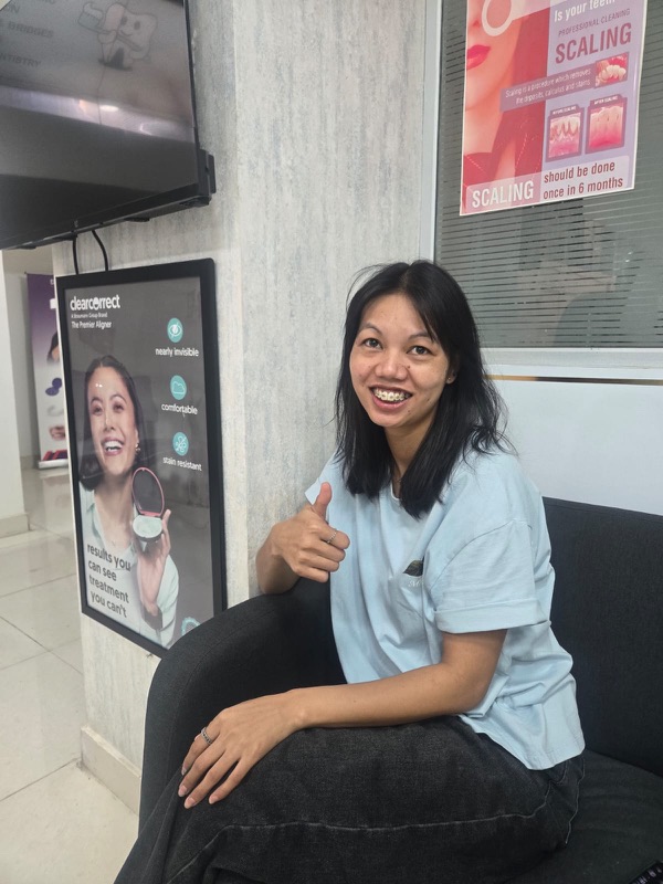 A happy patient giving a thumbs up after treatment at The Tooth Corner, Bellandur
