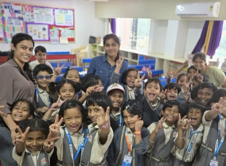Dr. Shabnam and her colleague with cheerful schoolchildren at a dental camp
