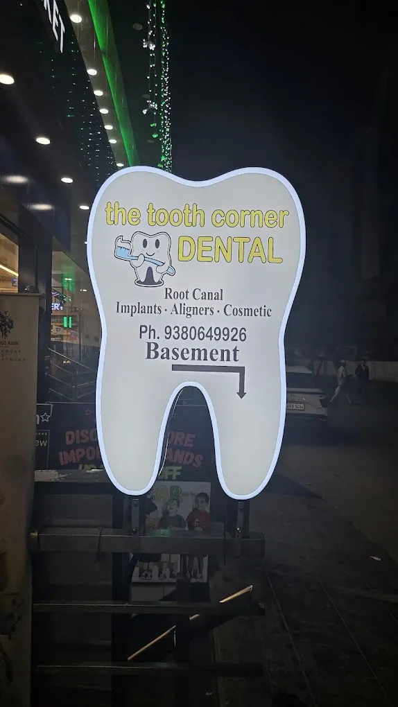The glowing tooth signboard at The Tooth Corner entrance in Green Glen Layout