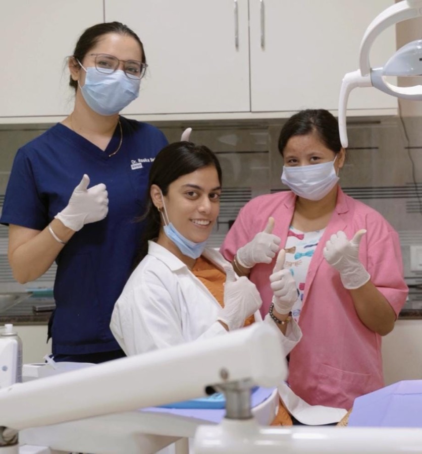 The Tooth Corner team giving a thumbs up with a happy patient in the treatment room